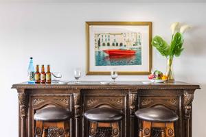 a bar with two stools and a painting of a boat at SEA 351 in Shirahama