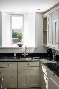 a kitchen with a sink and a window at The Old Chapel in Leyburn