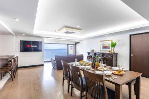 a dining room and living room with a table and chairs at SEA 351 in Shirahama