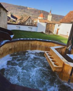 a hot tub in the backyard of a house at Castle View in Saschiz