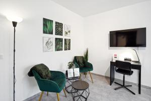 sala de estar con 2 sillas verdes y escritorio en 1 Zi. Wohnung, 34m², Parken, Messe DUS, en Duisburg