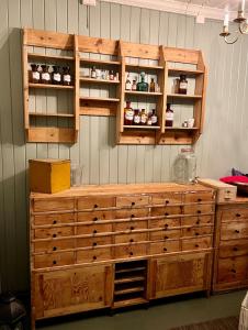 a wooden cabinet with drawers in a room at Apotekbygget in Nesbyen
