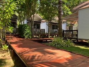 a wooden walkway in front of a house at Isle Beach Resort Krabi-SHA in Klong Muang Beach