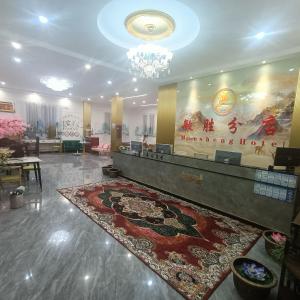 a lobby with a large rug on the floor at Minsheng Apartment in Guangzhou