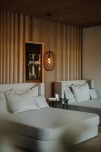 a bedroom with two beds and a table and a chandelier at Das Paradies in Laces +85 photos