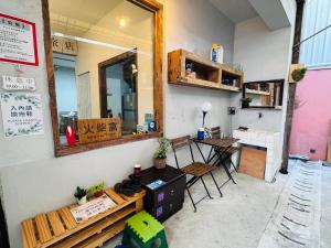 a room with a table and a mirror on the wall at MatchBox Hostel in Longjing