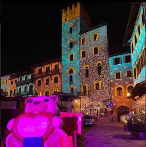 un oso de peluche rosa frente a un edificio en Casa Logge del Vasari, en Arezzo