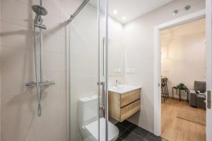 a bathroom with a shower and a toilet and a sink at MyHouseSpain - Glamour y confort cerca del Retiro in Madrid