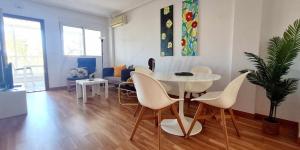 a living room with a white table and chairs at Appartement complètement rénové à San Pedro del Pinatar entre la Mar Menor et la Méditerranée. in San Pedro del Pinatar