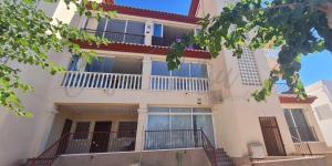 a large white building with balconies on the side of it at Appartement complètement rénové à San Pedro del Pinatar entre la Mar Menor et la Méditerranée. in San Pedro del Pinatar