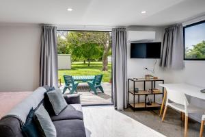 een woonkamer met een bank en een tafel bij Modern Studio near Clive River in Clive