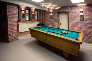 a pool table in a room with a brick wall at Комплекс Златна Кошута 