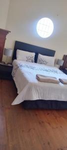 a bedroom with a large bed with two pillows at Tita comfortable home in Johannesburg