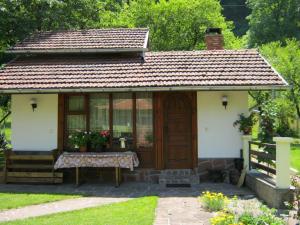 a small white house with a wooden door at Villa Lalka in Ribarica