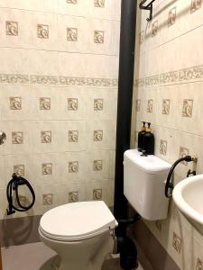 a bathroom with a white toilet and a sink at Andiana Hotel & Lodge - Kota Bharu City Centre in Kota Bharu