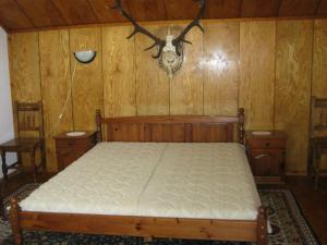 a bedroom with a bed and wood paneled walls at Villa Lalka in Ribarica