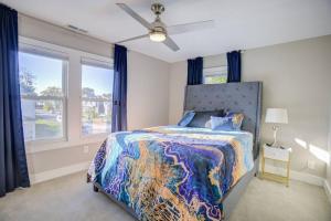 a bedroom with a bed and a ceiling fan at Fountain Gem: Your Urban Oasis in Indianapolis +9 photos