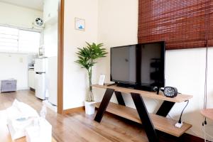 a flat screen tv sitting on a table in a living room at Daiichi Mitsumi Corporation - Vacation STAY 15349 in Musashino
