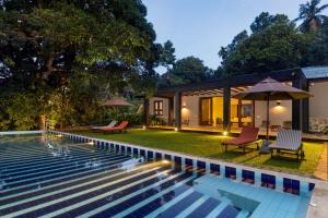a villa with a swimming pool at night at Mount Havana in Kandy