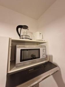 un horno de microondas con una olla encima en Appartment Del Pueblo/Netflix/Zentral/Ideal für 4! en Weiden