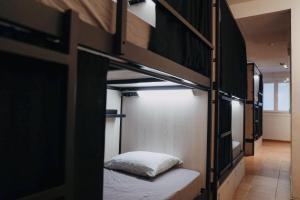 a room with two bunk beds with a pillow at Onefam Batlló in Barcelona +18 photos