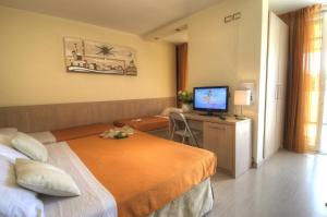 Postel nebo postele na pokoji v ubytování Hotel Colorado