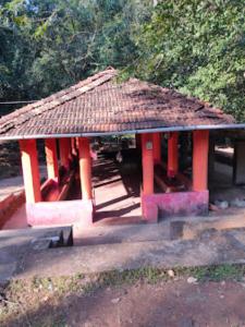 a small building with a roof on top of it at Vanoshi Forest Homestay,Kudase in Maneri