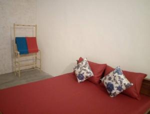 a red couch with pillows and a chair in a room at Full Large room in Colombo