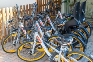 a row of bikes parked next to a fence at Hotel Consul Dipendenza "la Plata" con piscina in Riccione