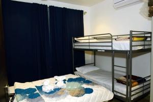 two bunk beds in a room with blue curtains at alibaug serenity villa in Alibaug