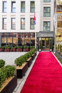 a red carpet in front of a building at Signature London, The J Marylebone in London