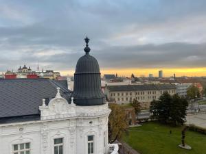 a white building with a dome on top of it at Prostě Terezská in Olomouc