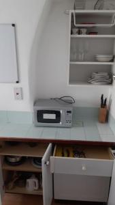 a kitchen with a counter top with a microwave at SOHO Flat (Central London) in London