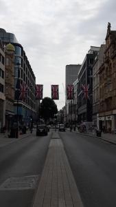 a city street with flags in the middle of the road at SOHO Flat (Central London) in London