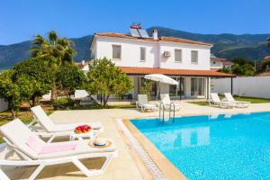 a villa with a swimming pool and a house at Villa Oliv in Oludeniz