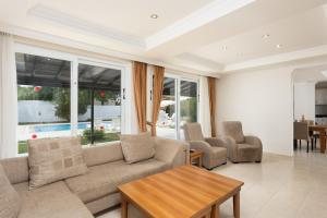 a living room with a couch and chairs and a table at Villa Oliv in Oludeniz