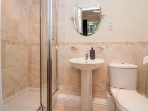 a bathroom with a toilet and a sink and a shower at Fell Haven in St Bees