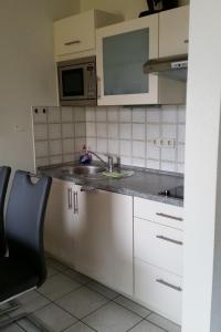 a kitchen with a sink and a microwave at Appartment 1021, Missen-Wilhams in Missen-Wilhams