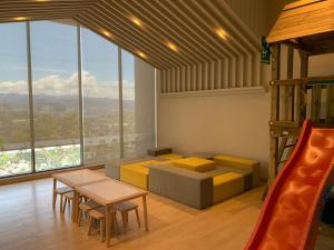 a room with a bed and a table and chairs at Greystone Continew Residensi in Kuala Lumpur