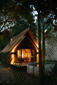 a small cabin in the woods at night at Treellion Jungloo in Phnom Penh