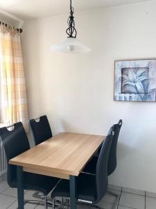a dining room table with chairs and a light fixture at Appartment 1021, Missen-Wilhams in Missen-Wilhams