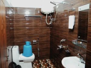 a bathroom with a toilet and a sink at Shungatser inn in Tawang