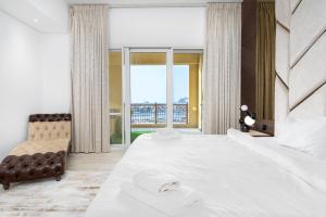 a bedroom with a large bed and a large window at SEA and ATLANTIS VIEW COZY 3BR RESORT PALM JUMEIRAH in Dubai