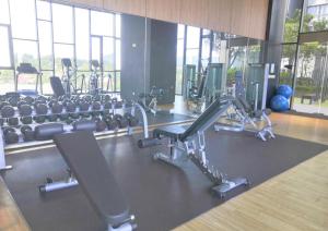 a gym with several treadmills and machines at DSara Cozy Homestay, 1-5Pax - DS1 in Sungai Buluh