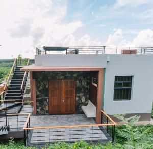 a house with a staircase leading up to it at Sky Hill Villa SuratThani in Suratthani