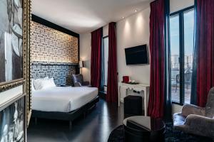 a hotel room with a bed and a large window at Vincci Vía - 66 in Madrid