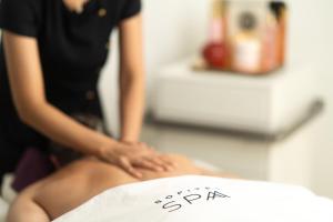 a woman sitting on top of a spa sign at Sofitel Rabat Jardin Des Roses in Rabat