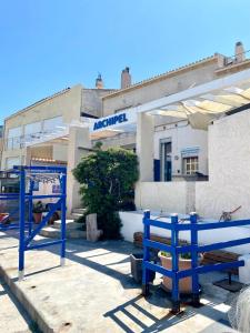 a blue bench in front of a building at L'Annexe de la Madrague Marseille in Marseille