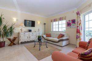 a living room with a couch and a table at Casa Presa da Moura in Carvoeiro