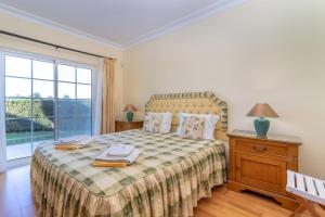a bedroom with a bed and a large window at Casa Presa da Moura in Carvoeiro +21 photos